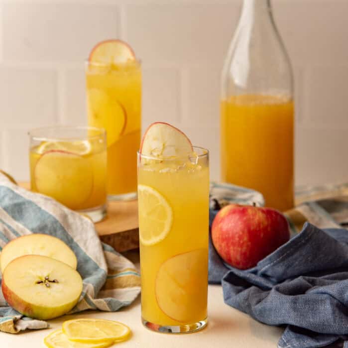 Square image of apple lemonde served in a glass.
