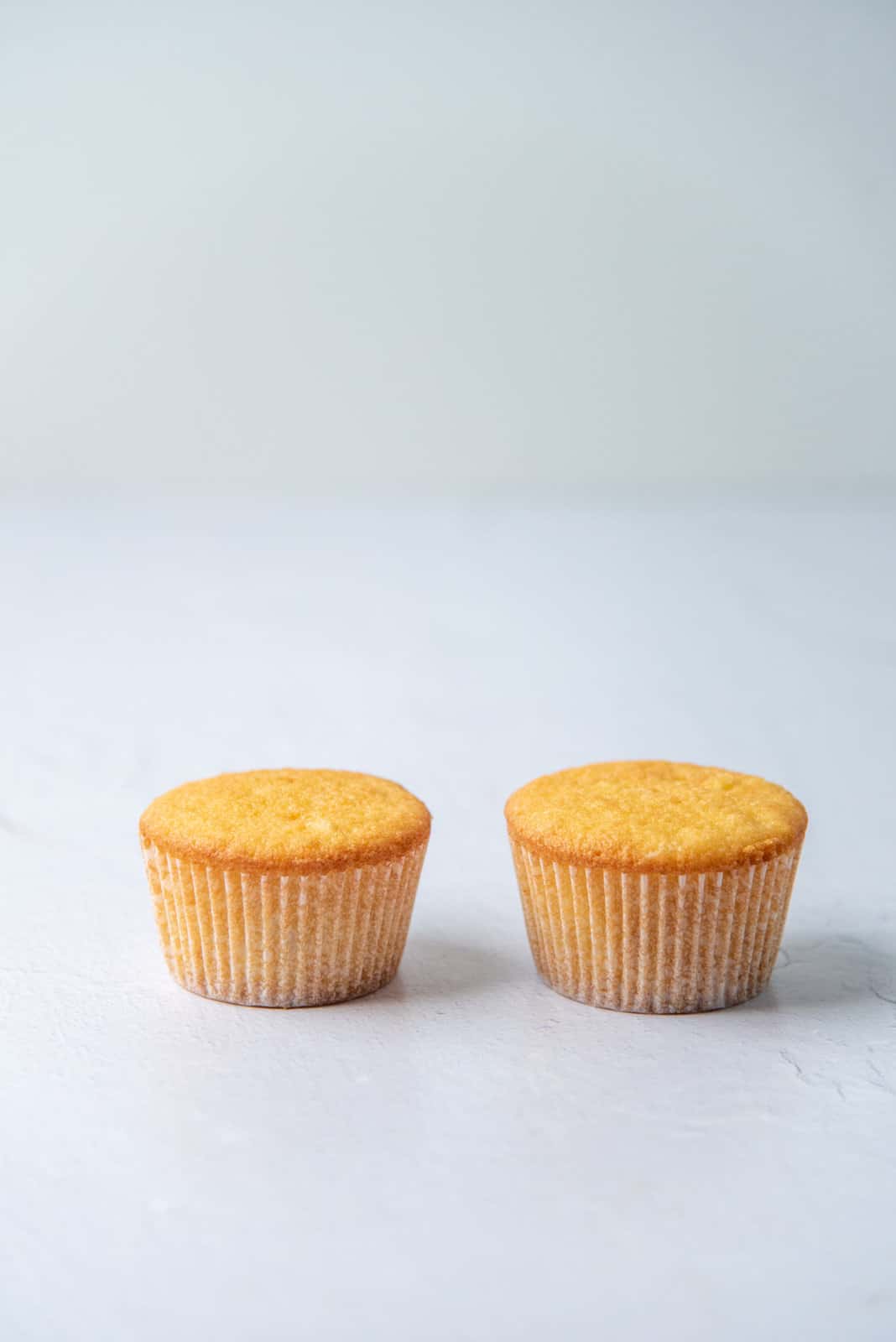 Two cupcakes with differing heights to show the difference of leaveners in cakes.