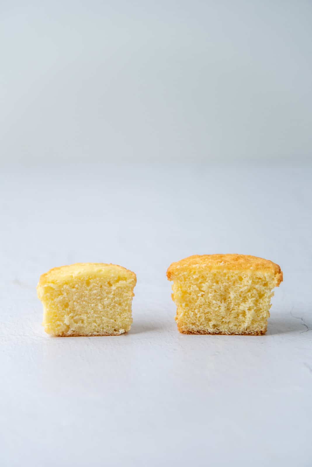 Two cupcakes cut in half to show the crumb in the cake.