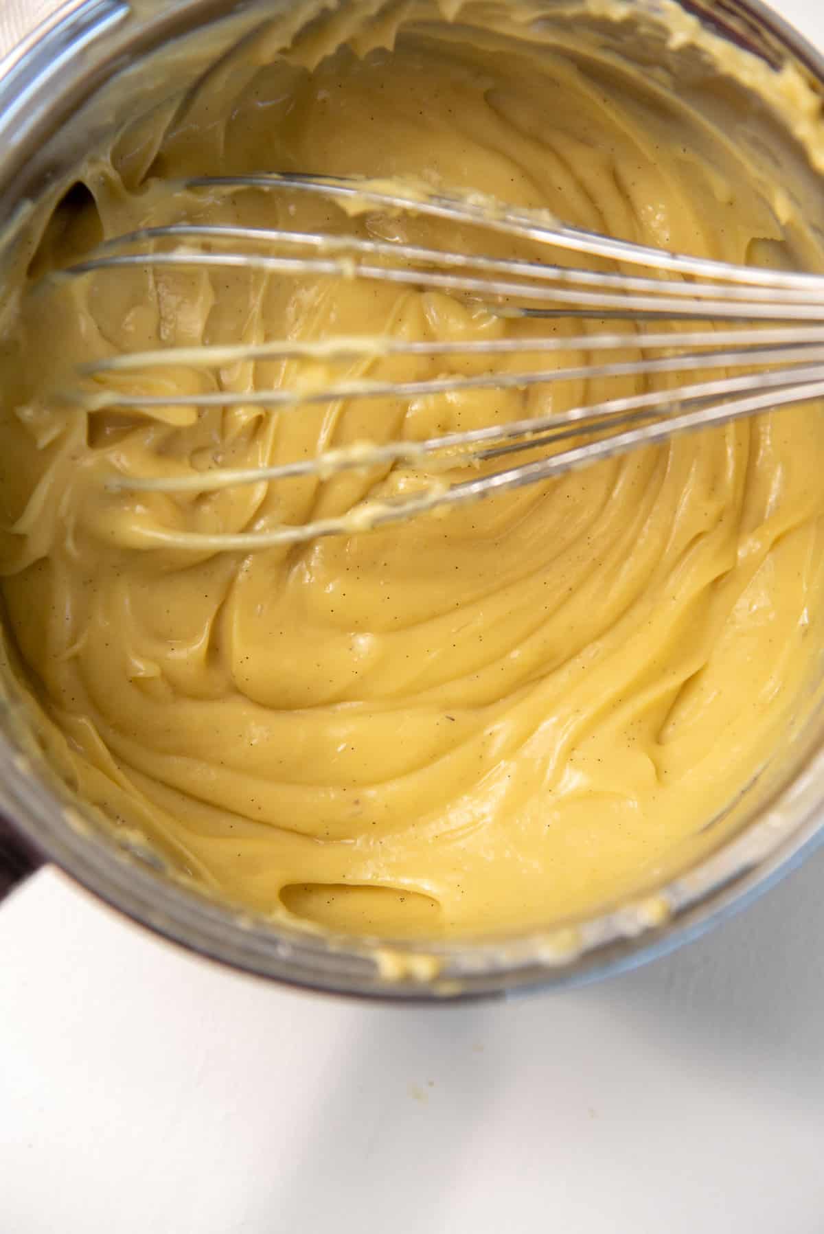 Overhead close up of the smooth banana pudding pastry cream after mixing in the butter and gelatin.