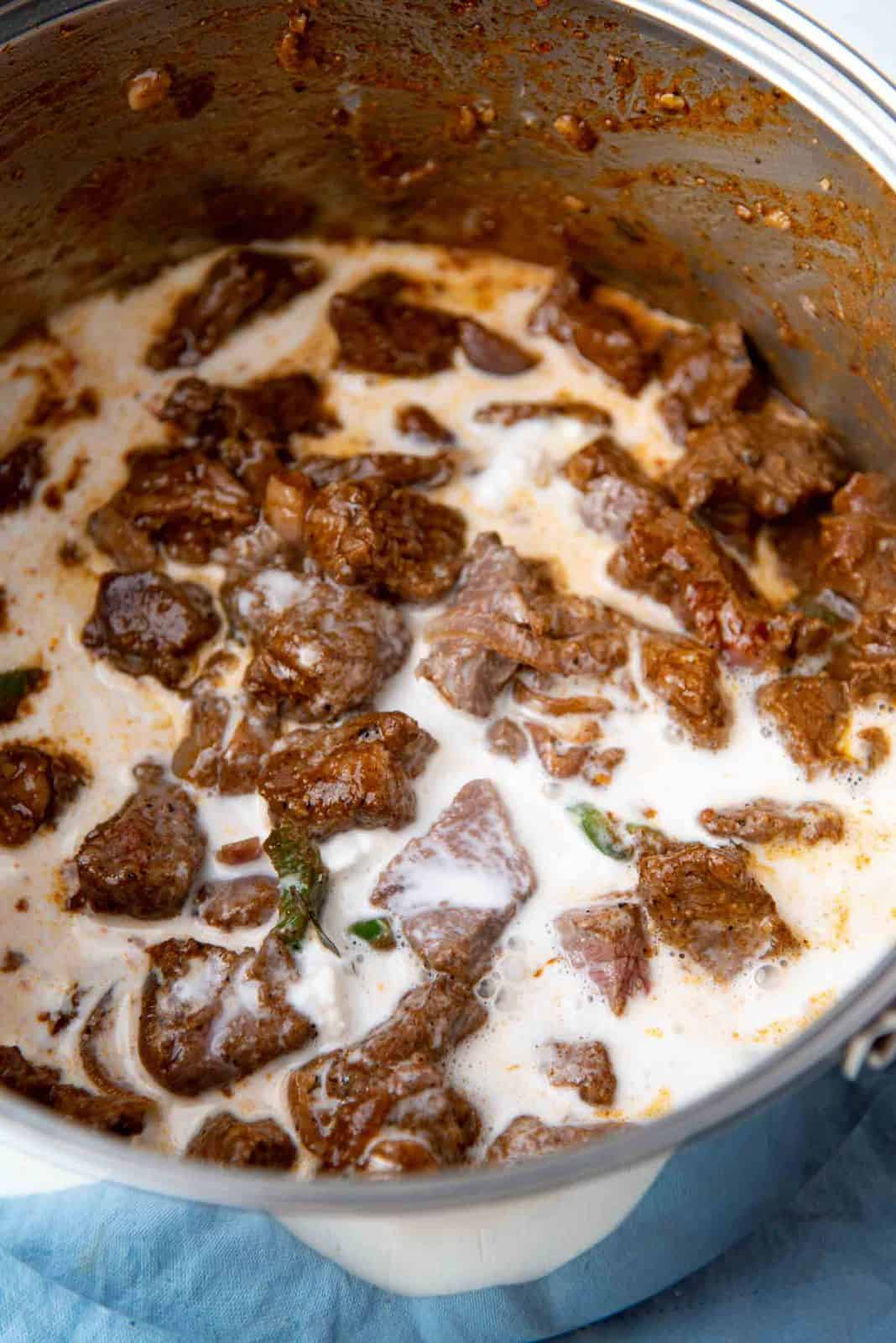 Adding the coconut milk into the curry