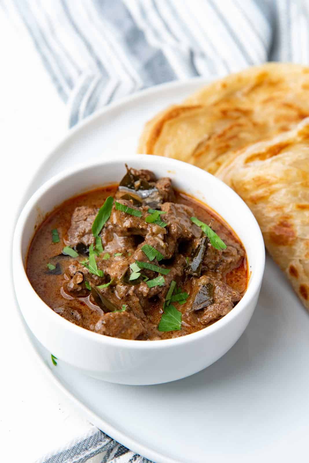Beef curry served in a white bowl