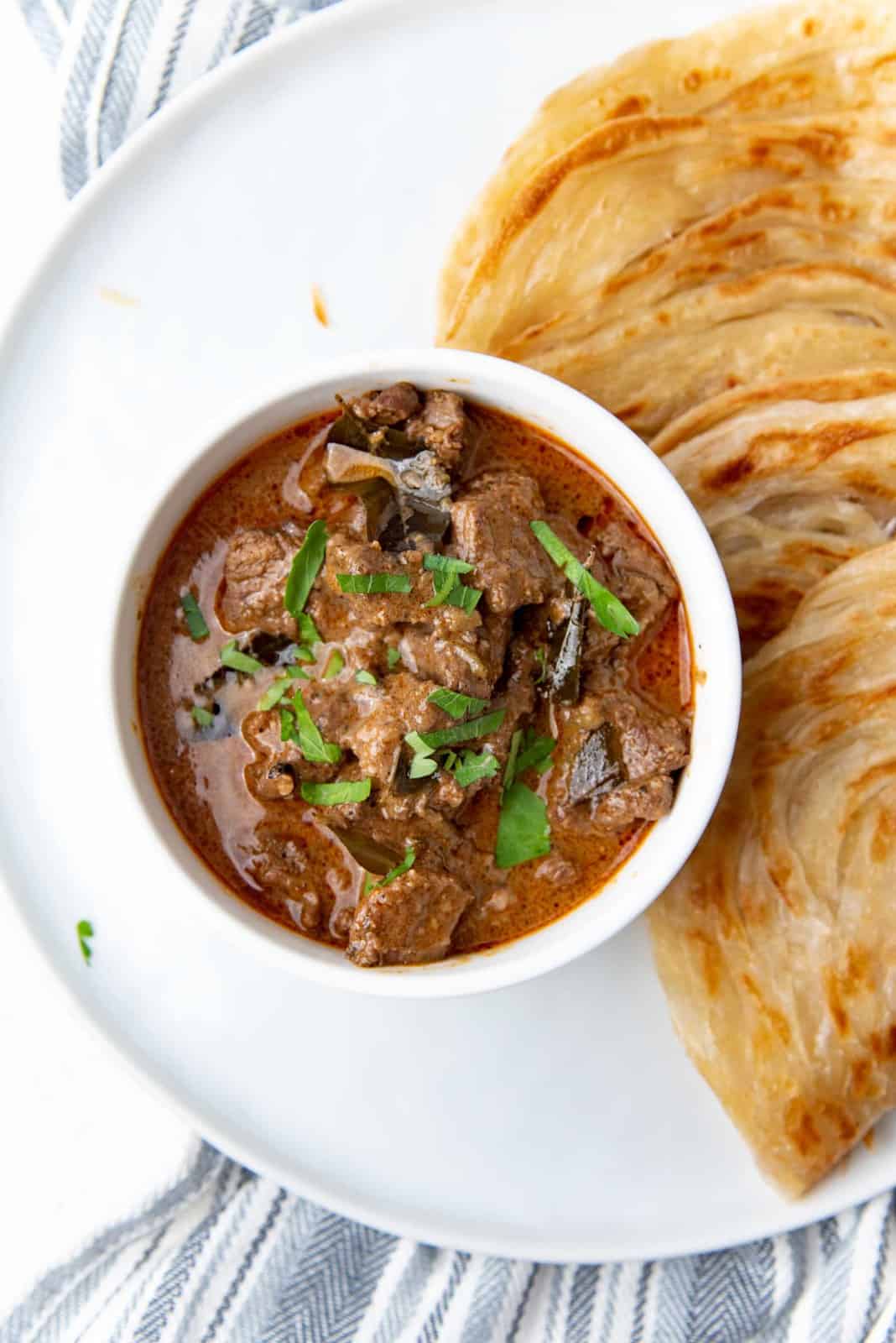 Overhead view of the Sri Lankan beef curry in a bowl with roti