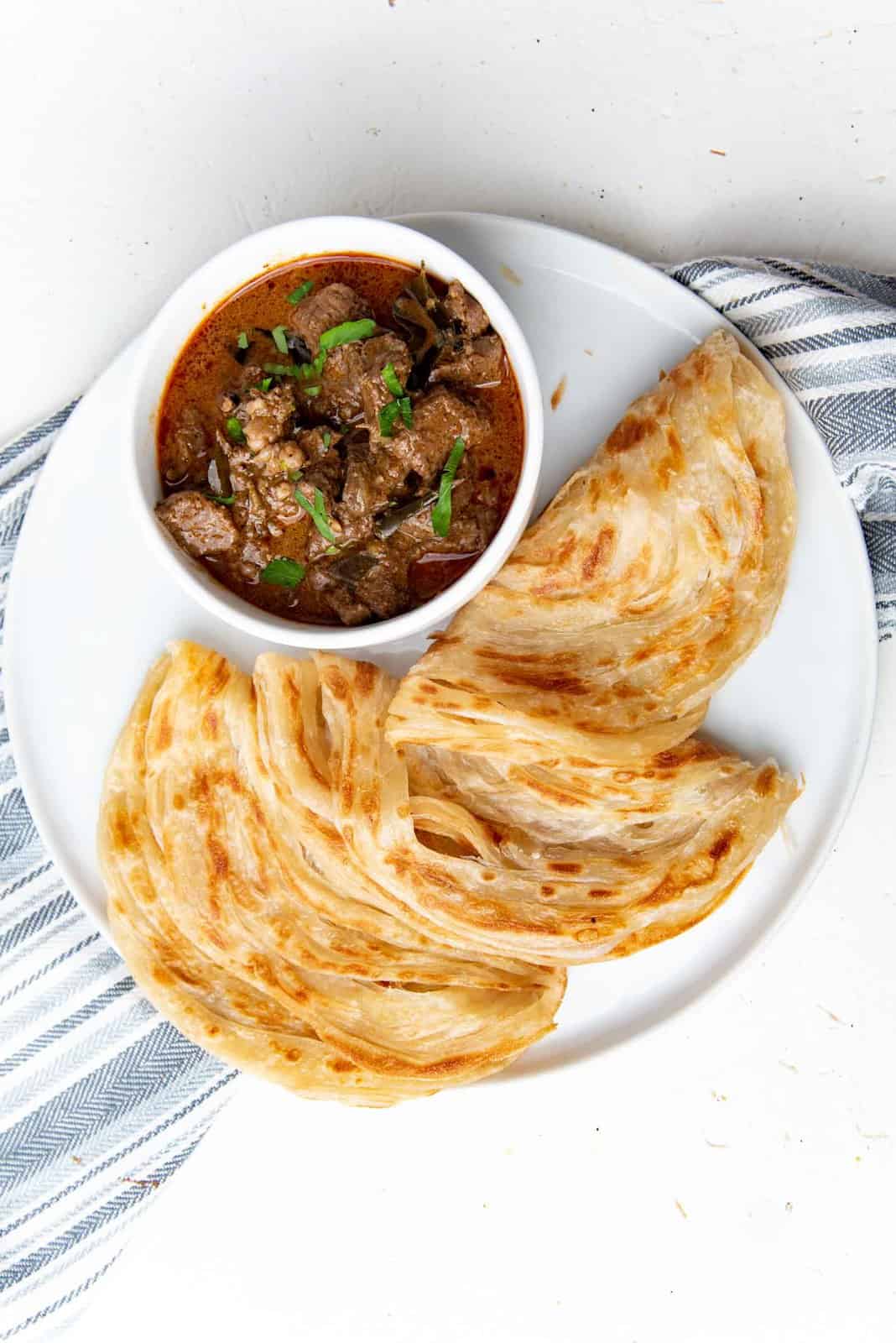 Beef curry overhead view with roti