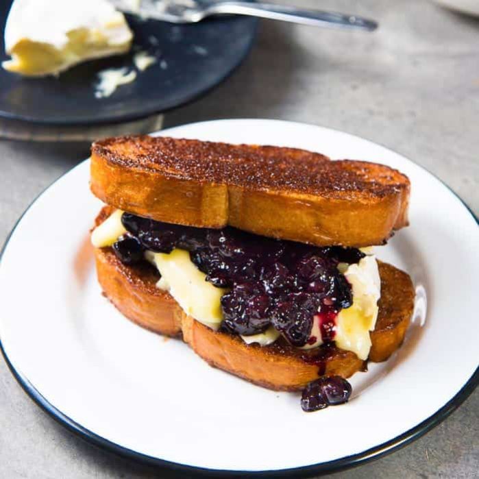 Roasted Blueberries and Brie with Cinnamon Toast - A simple, yet fancy, versatile dessert of brunch. Buttery, crunchy, sweet, salty cinnamon toast topped with a fruity blueberry compote and creamy brie.