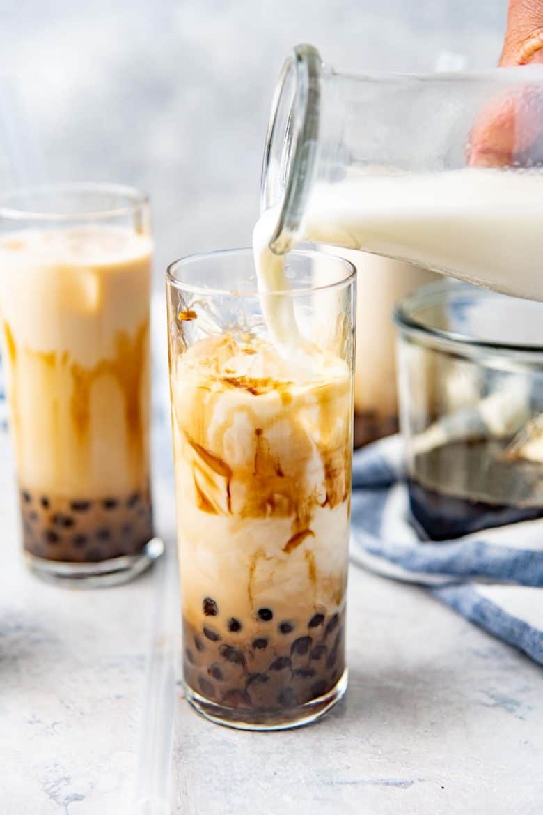 Pouring the milk to make brown sugar bubble tea