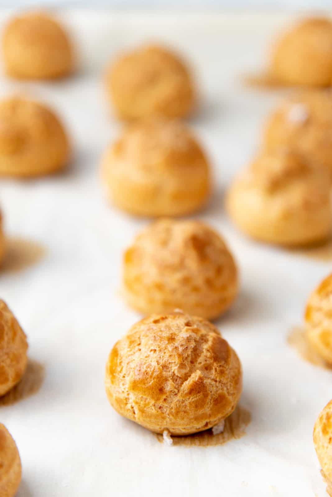 Freshly baked choux pastry on the baking sheet