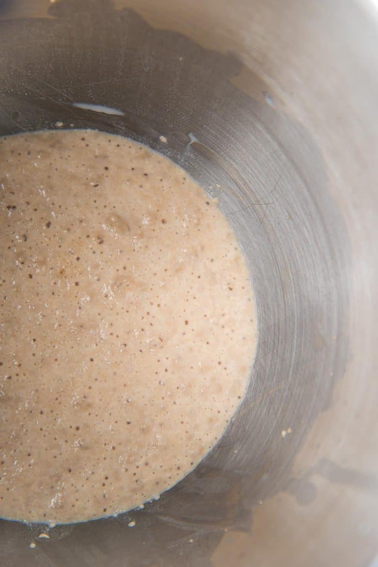 Activated yeast is frothy and bubbly in the milk in the mixing bowl. 