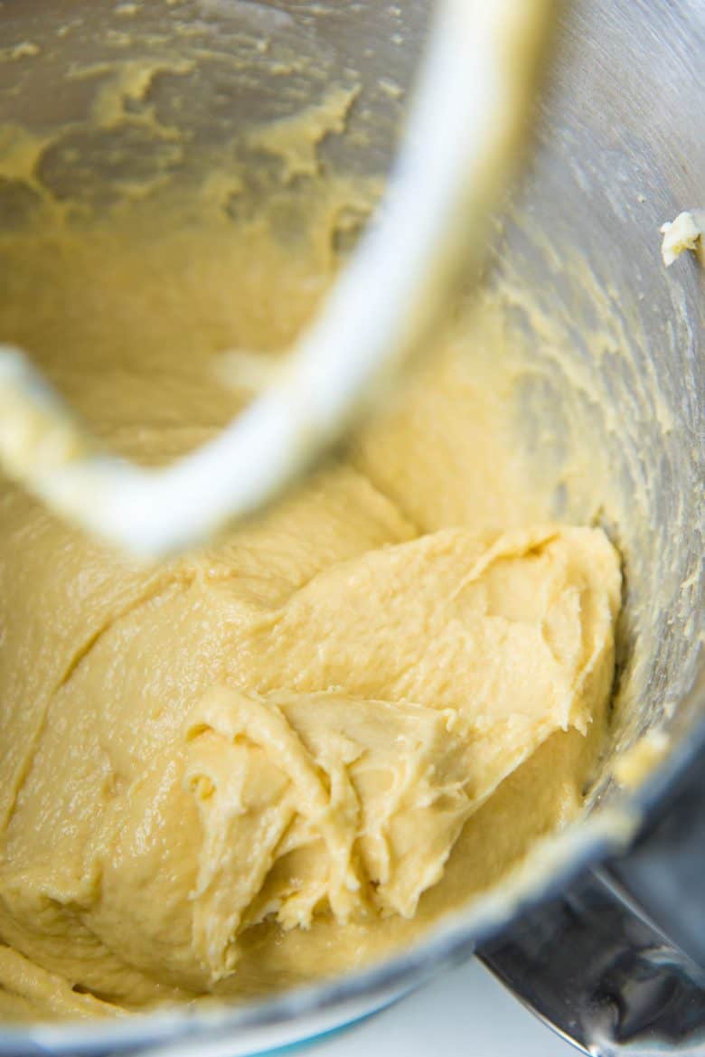 Adding butter to a very wet brioche dough in the mixing bowl. 