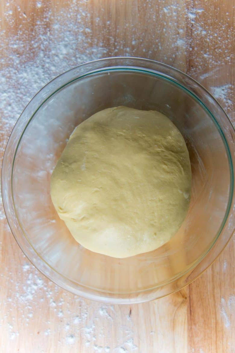 Brioche dough in a glass bowl before the first proof.
