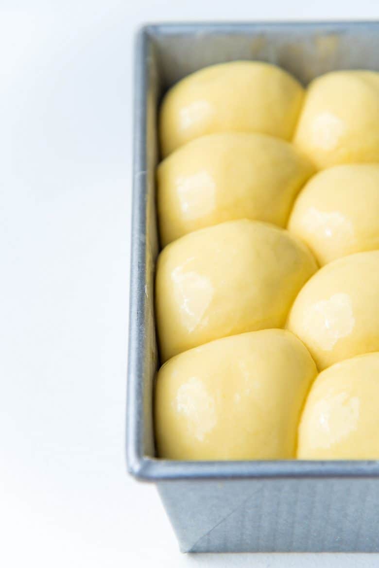 Properly proofed nantaise brioche loaf in a loaf pan before baking. 