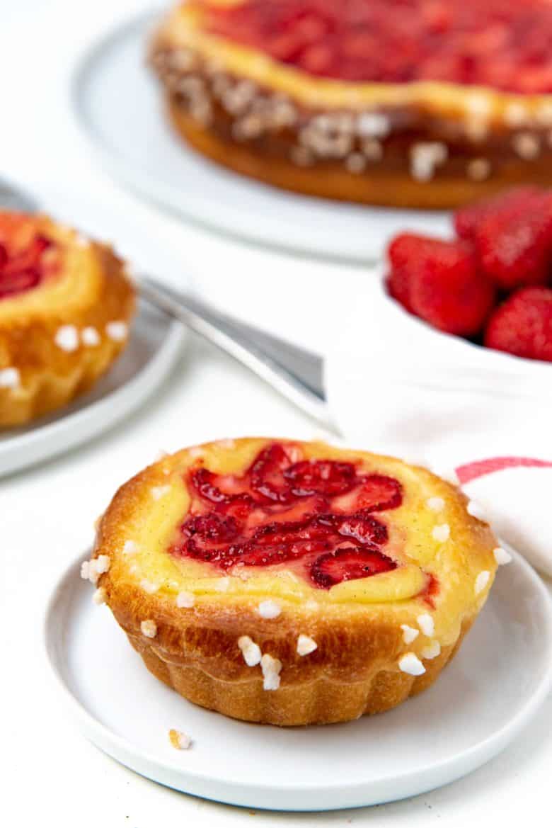 A single brioche custard tart served on a small plate