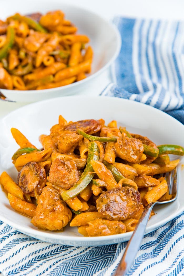 Two bowls of creamy cajun chicken pasta with one bowl in the foreground.