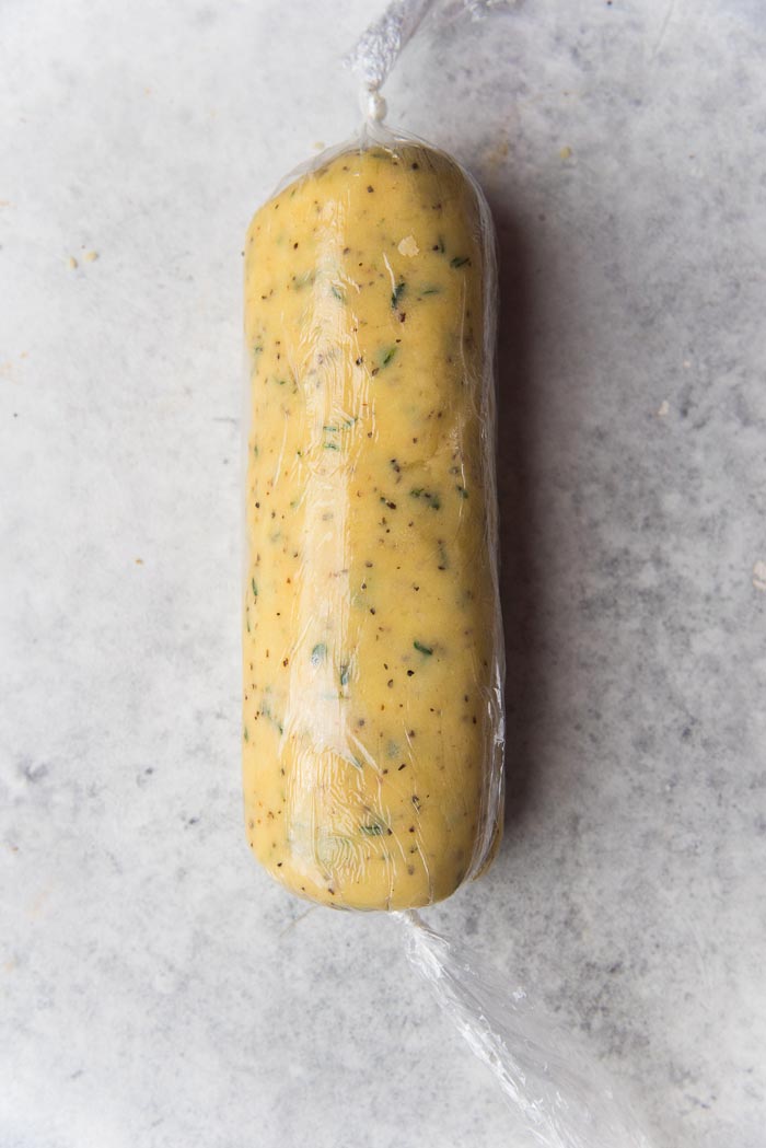 Recipe process for making thyme and cheddar cheese cookies - The slice and bake cheese cookie log wrapped tightly in plastic wrap