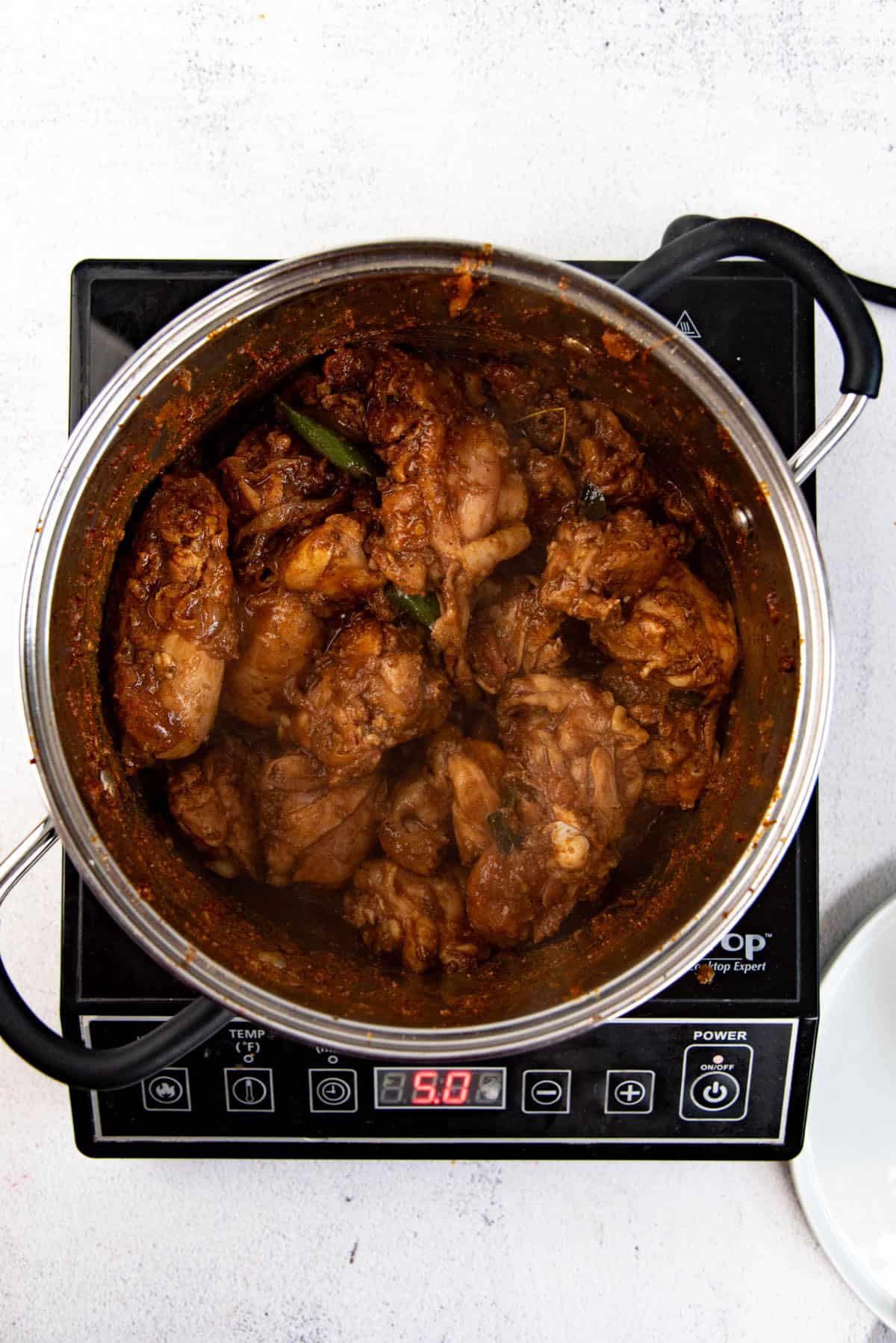 The chicken curry after the initial simmering with curry powder.