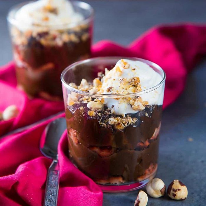 Chocolate Hazelnut Trifle - Layers of silky smooth hazelnut liqueur flavored chocolate mousse, and hazelnut liqueur soaked ladyfingers, topped with crunchy hazelnut praline and whipped cream