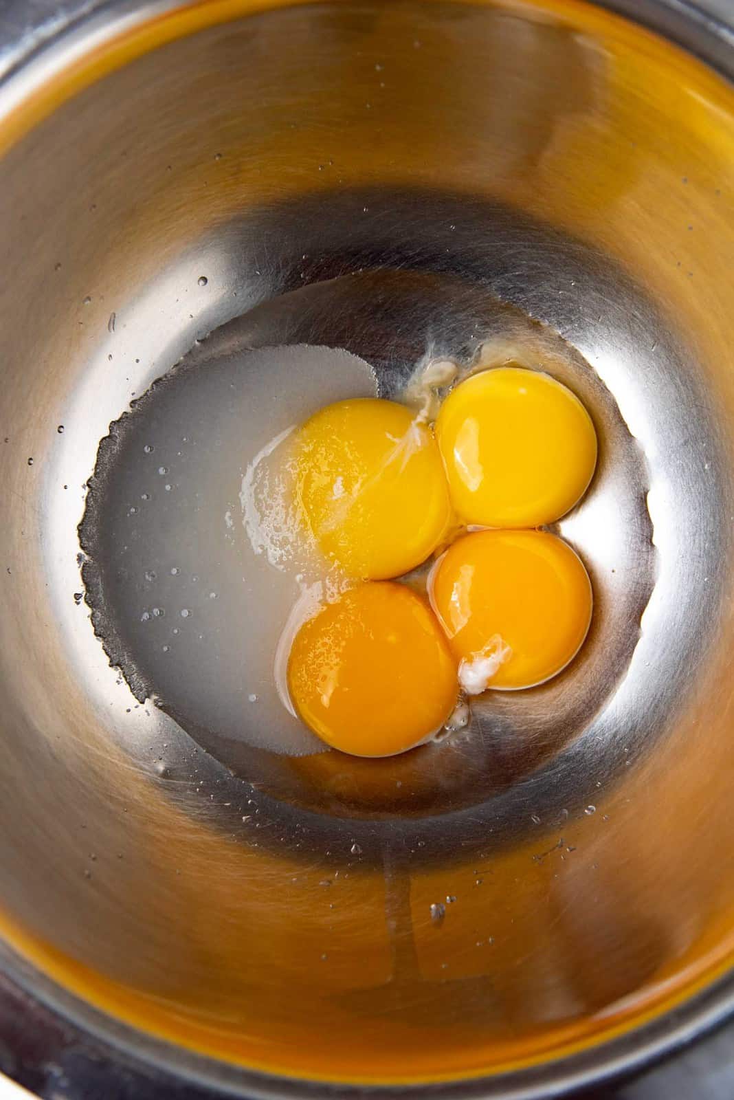 Egg yolks, water and sugar in a bow