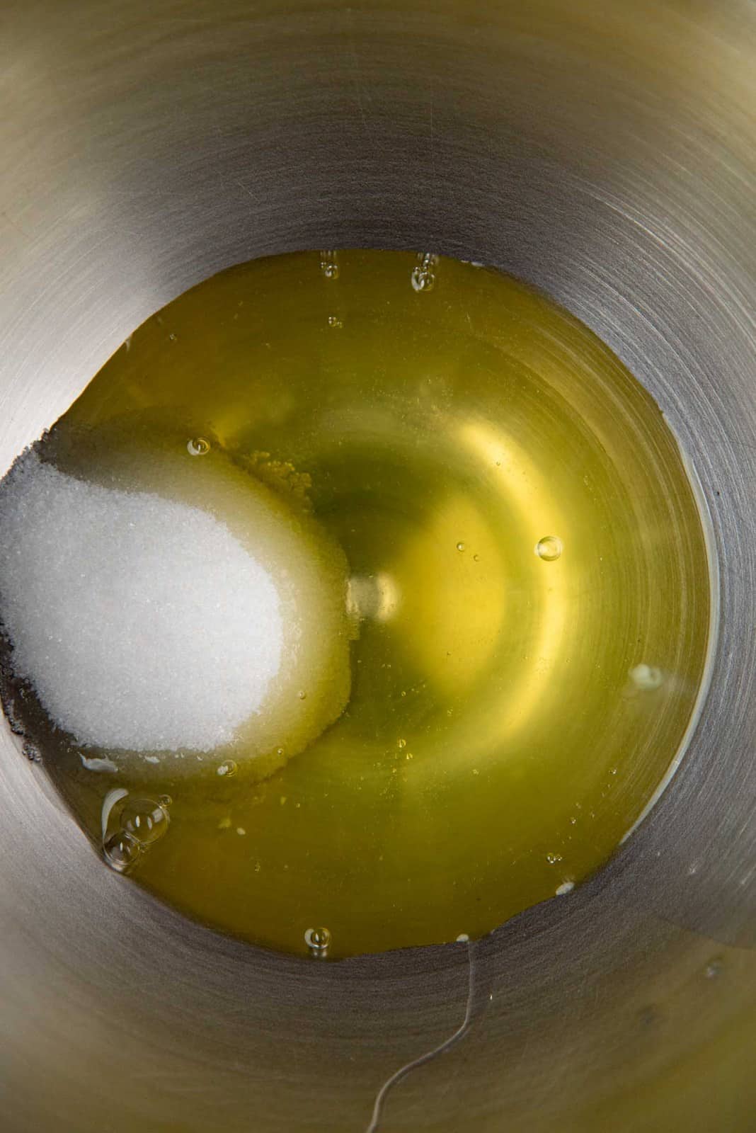 Egg whites and sugar in a metal bowl
