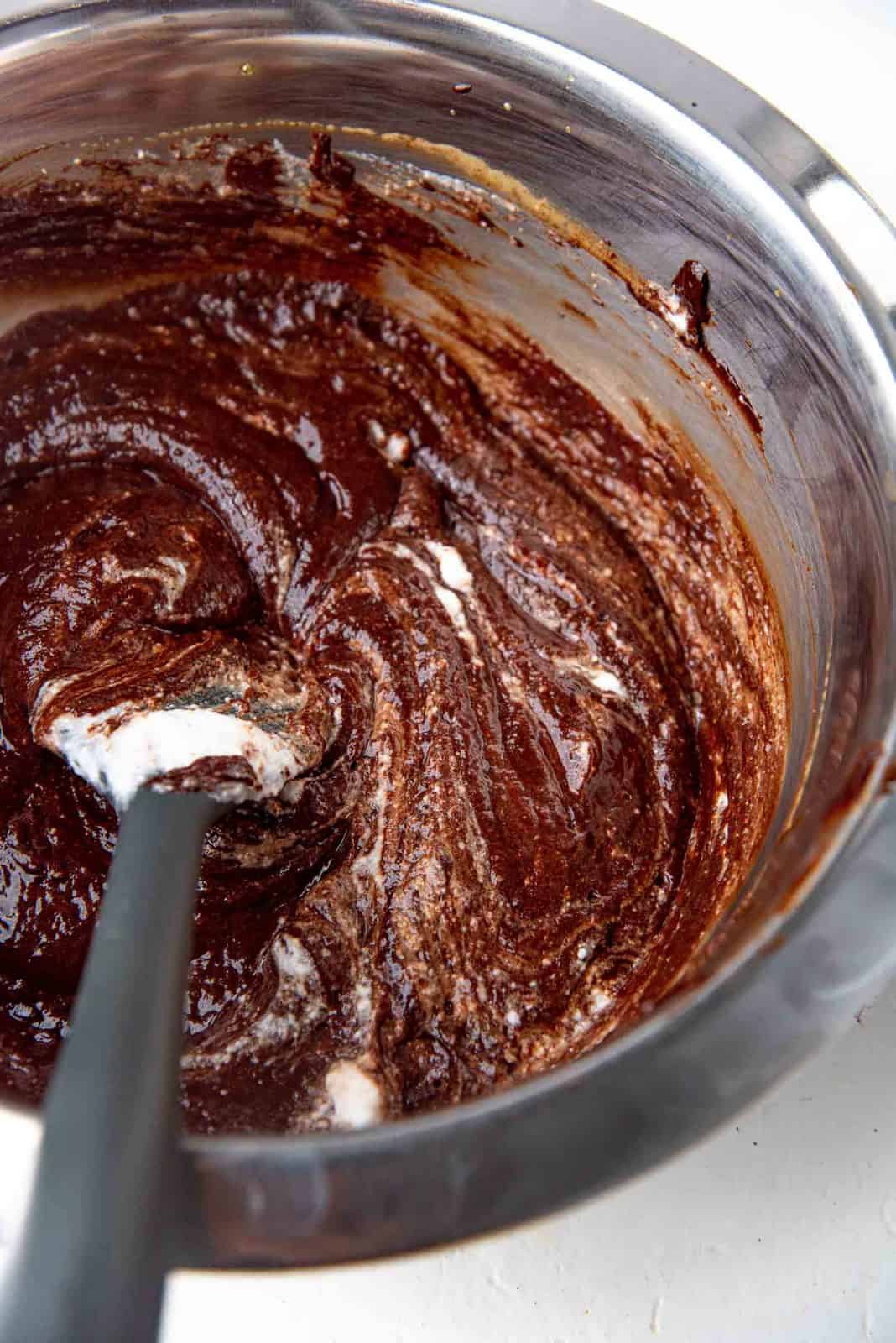 Chocolate folded in with egg white in a bowl