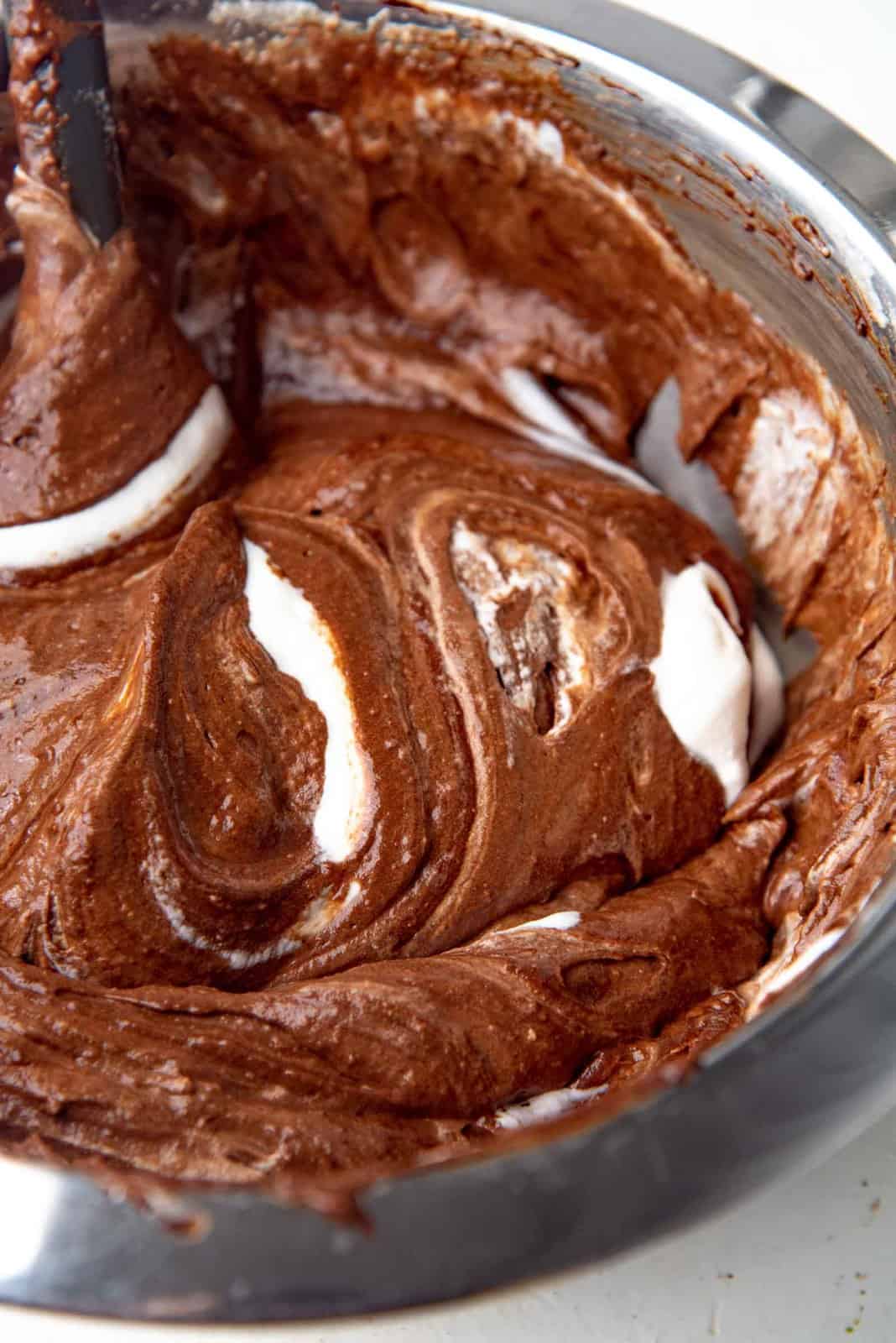 Folding in the cream into the chocolate mixture to make mousse