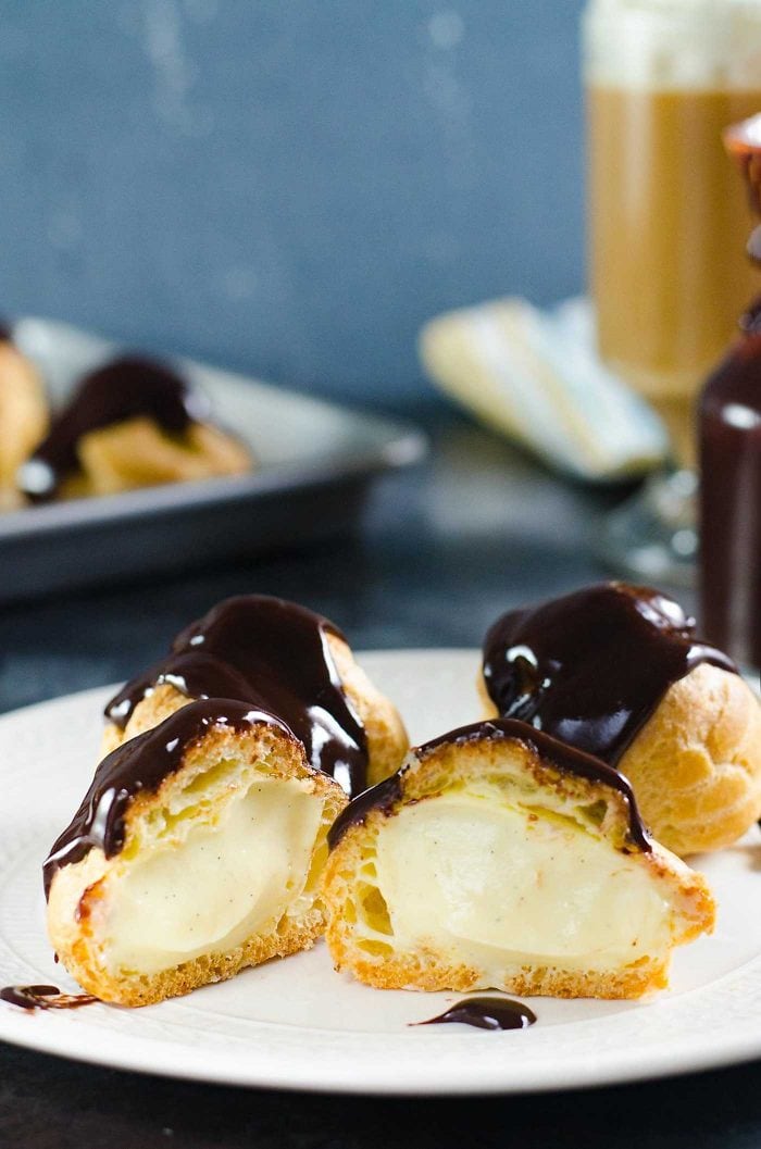 Chocolate Profiteroles with Pastry Cream (Cream Puffs) - rich, creamy custard filling inside light, airy, crispy, perfectly baked choux pastry shells, and then drizzled with a luscious chocolate sauce on top. 