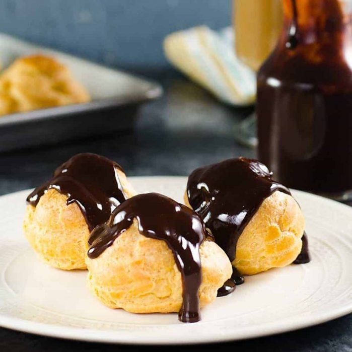 Chocolate Profiteroles with Pastry Cream (Cream Puffs) - rich, creamy custard filling inside light, airy, crispy, perfectly baked choux pastry shells, and then drizzled with a luscious chocolate sauce on top. 