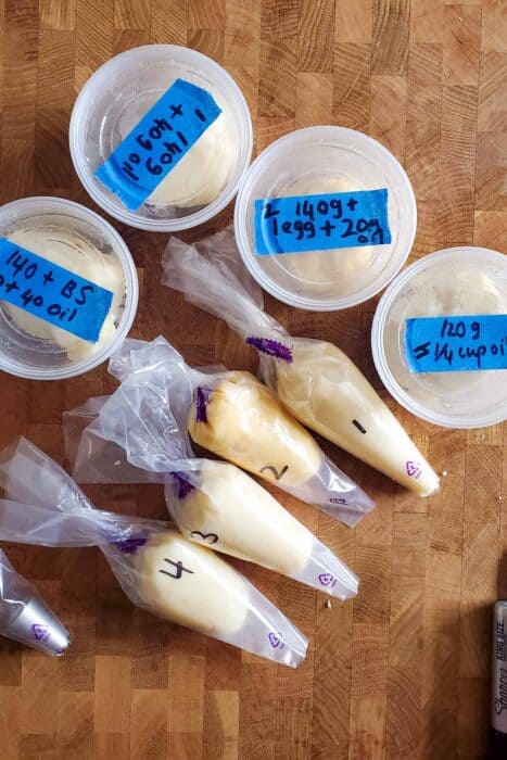 The four types of churro doughs in individual piping bags with numbers written on them.
