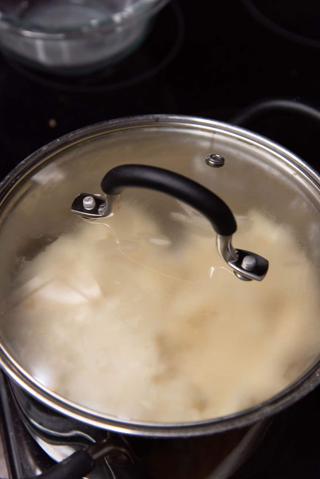 The cooked water dough for churros in the pot with the lid on.
