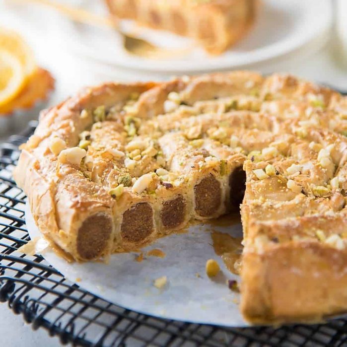 Citrus, Date and Almond M’hencha with Orange blossom honey syrup - A delicious and exotic Moroccan delicacy! A sweet date and almond paste wrapped in honey syrup soaked filo pastry.  It tastes just as amazing as it looks!