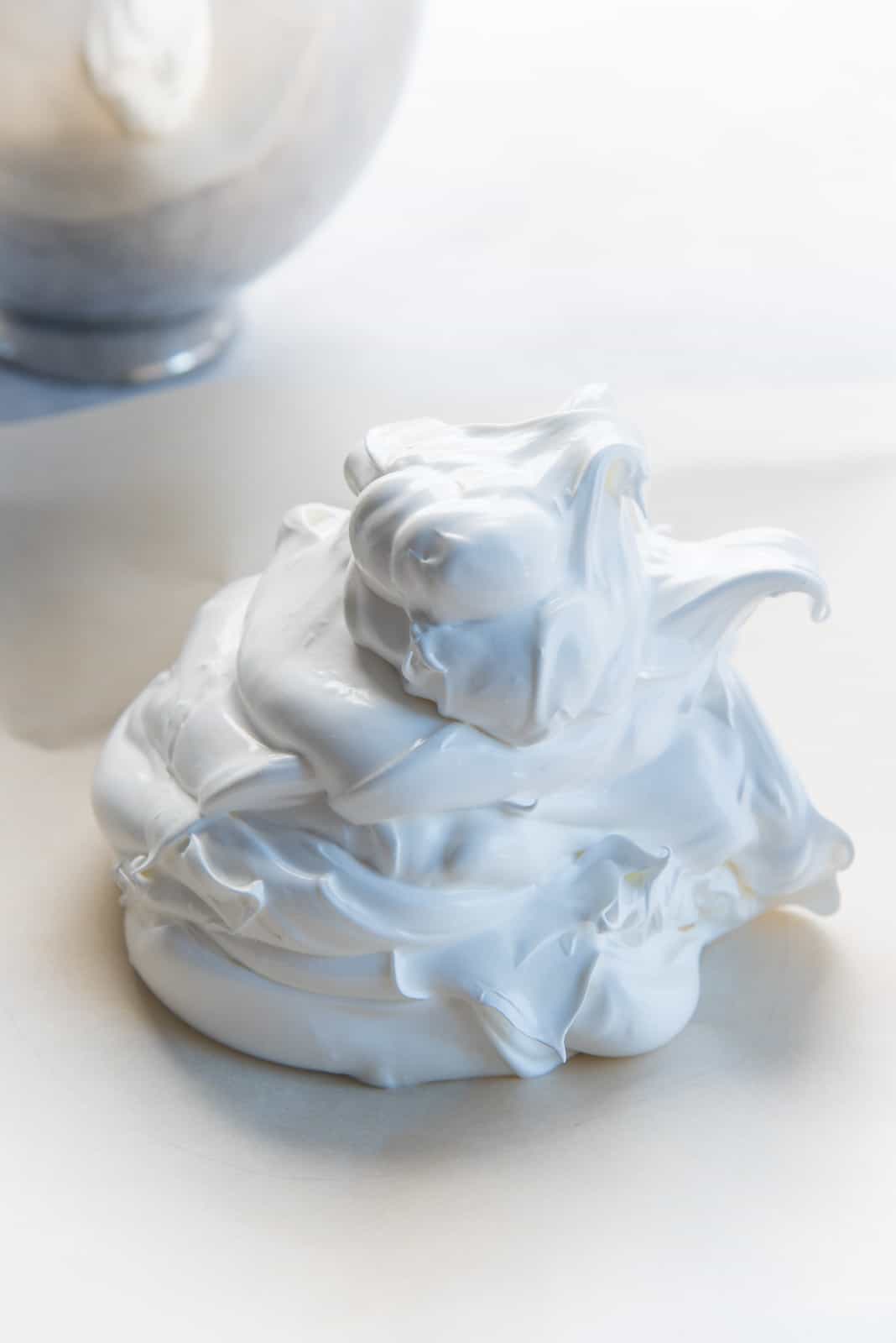 How to make pavlova - A pile of meringue on the prepared parchment.