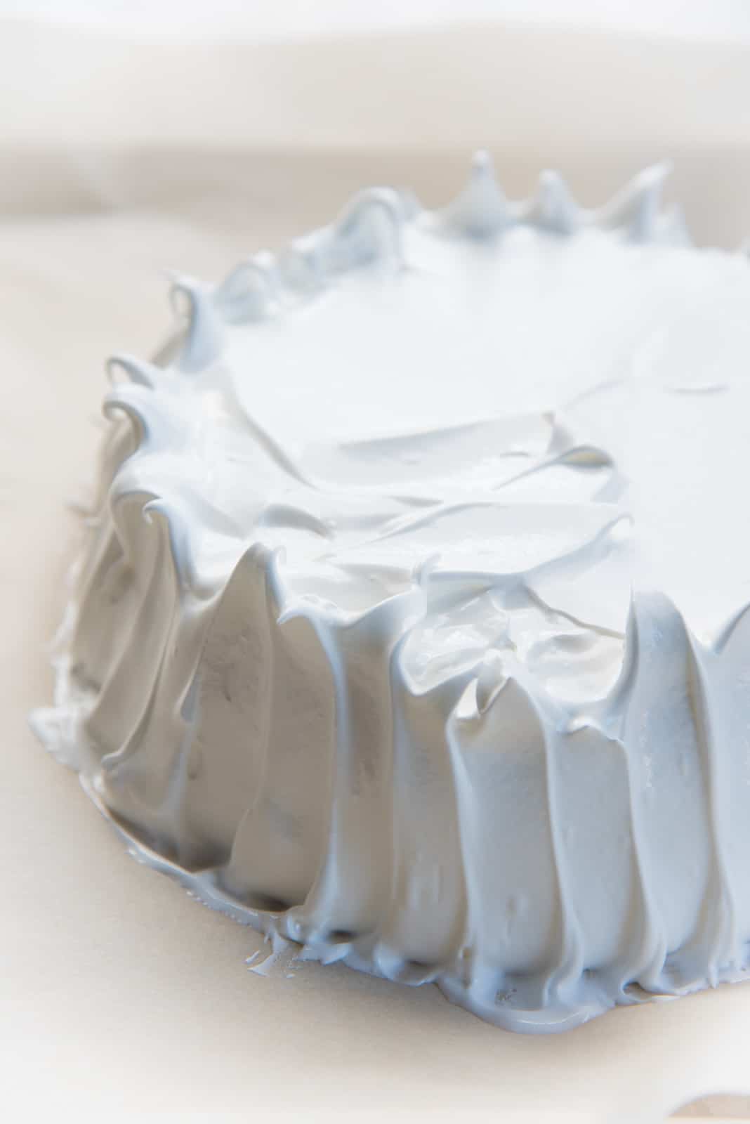 How to make pavlova - Creating furrows on the side of the pavlova to help with even baking.