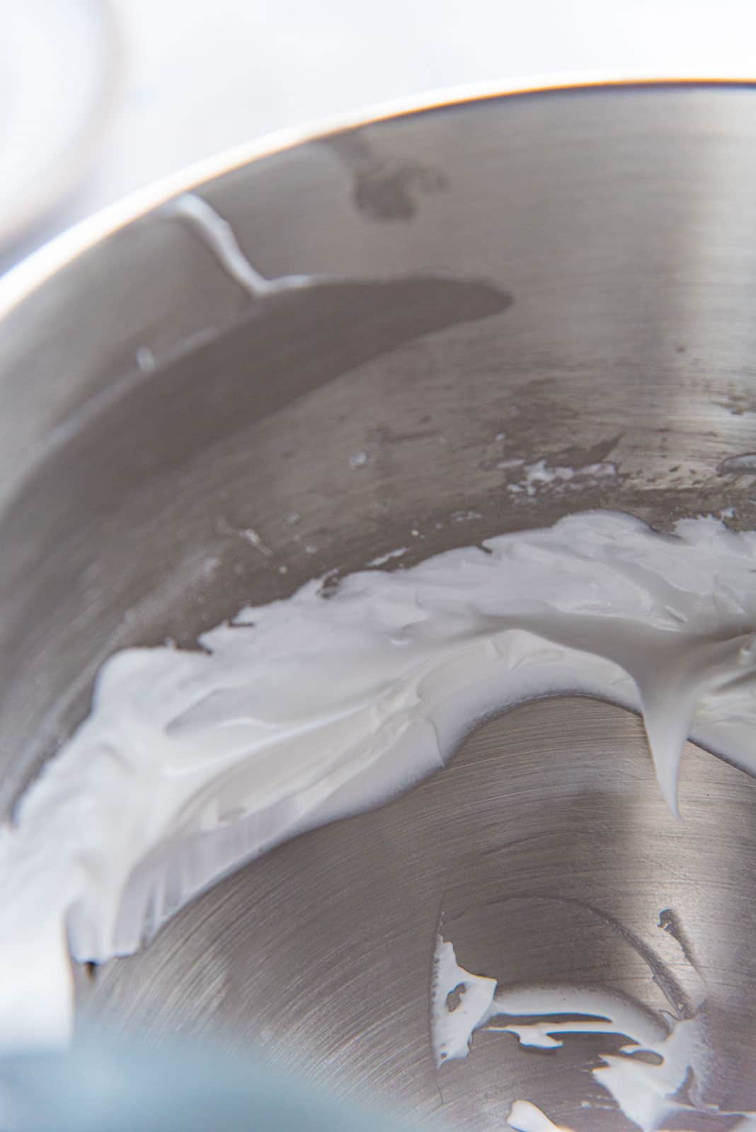 Scooping out the pavlova meringue, avoiding the edge, so that you avoid any undissolved sugar