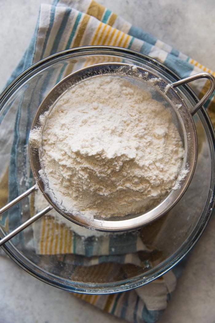Flour in a sieve, over a bowl. Make sure to sift the flour before adding it to the batter. 