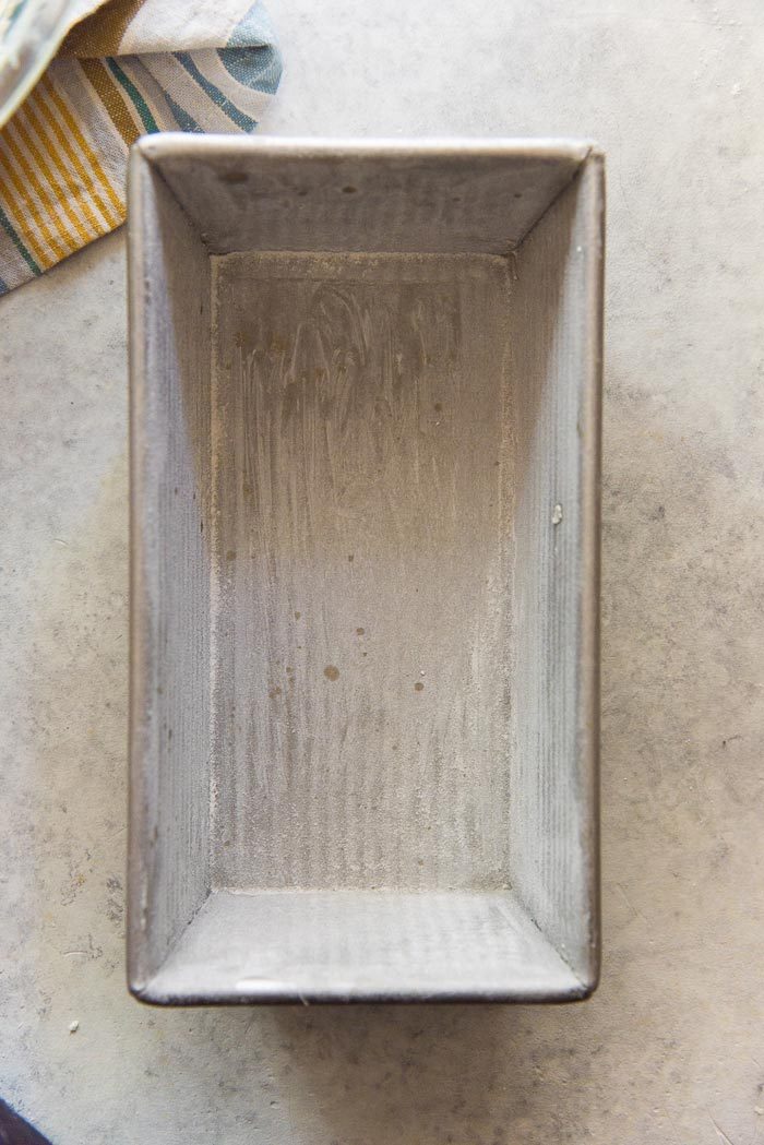 A buttered and floured loaf pan to bake pound cake. This is the traditional size and shape of a pound cake pan.