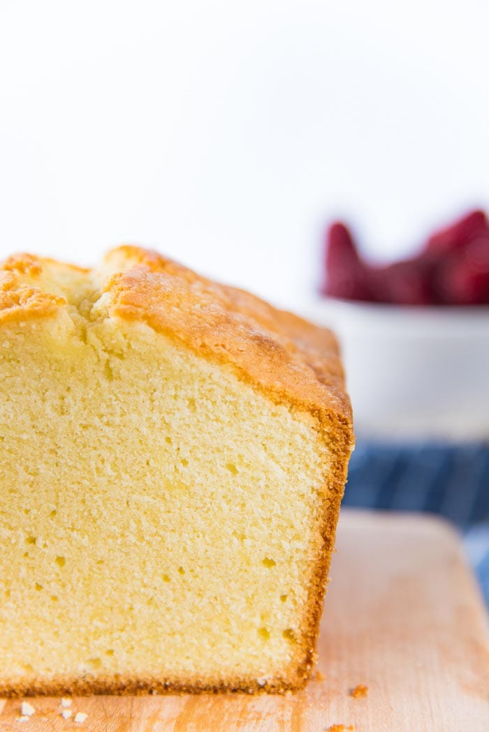 A close up look at the sliced pound cake. The crumb is close, but moist and soft, with a thin brown outer crust. 