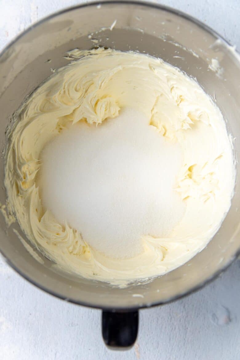 Adding sugar to the butter in the mixing bowl