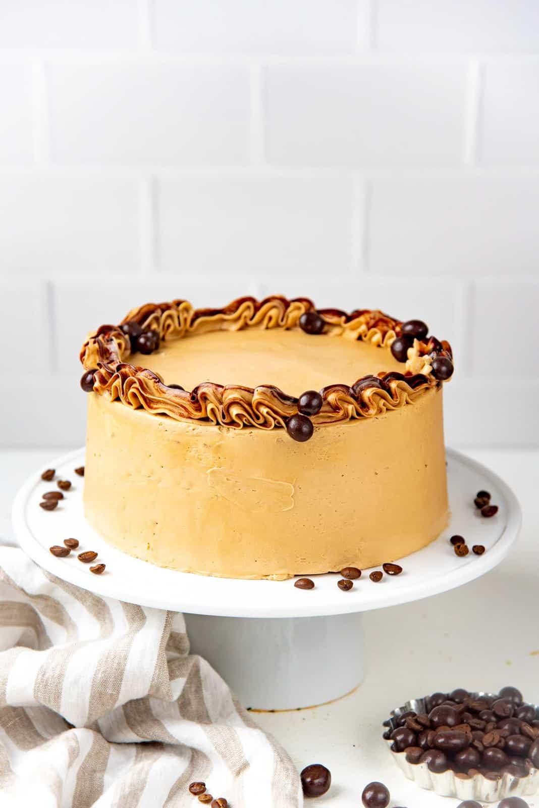 Coffee layer cake with coffee buttercream on a cake stand