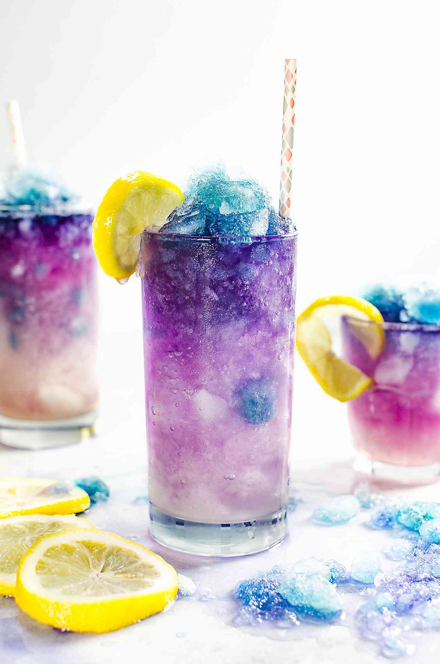 Glass of color changing lemonade slushie with a color gradient of blue to purple to pink.