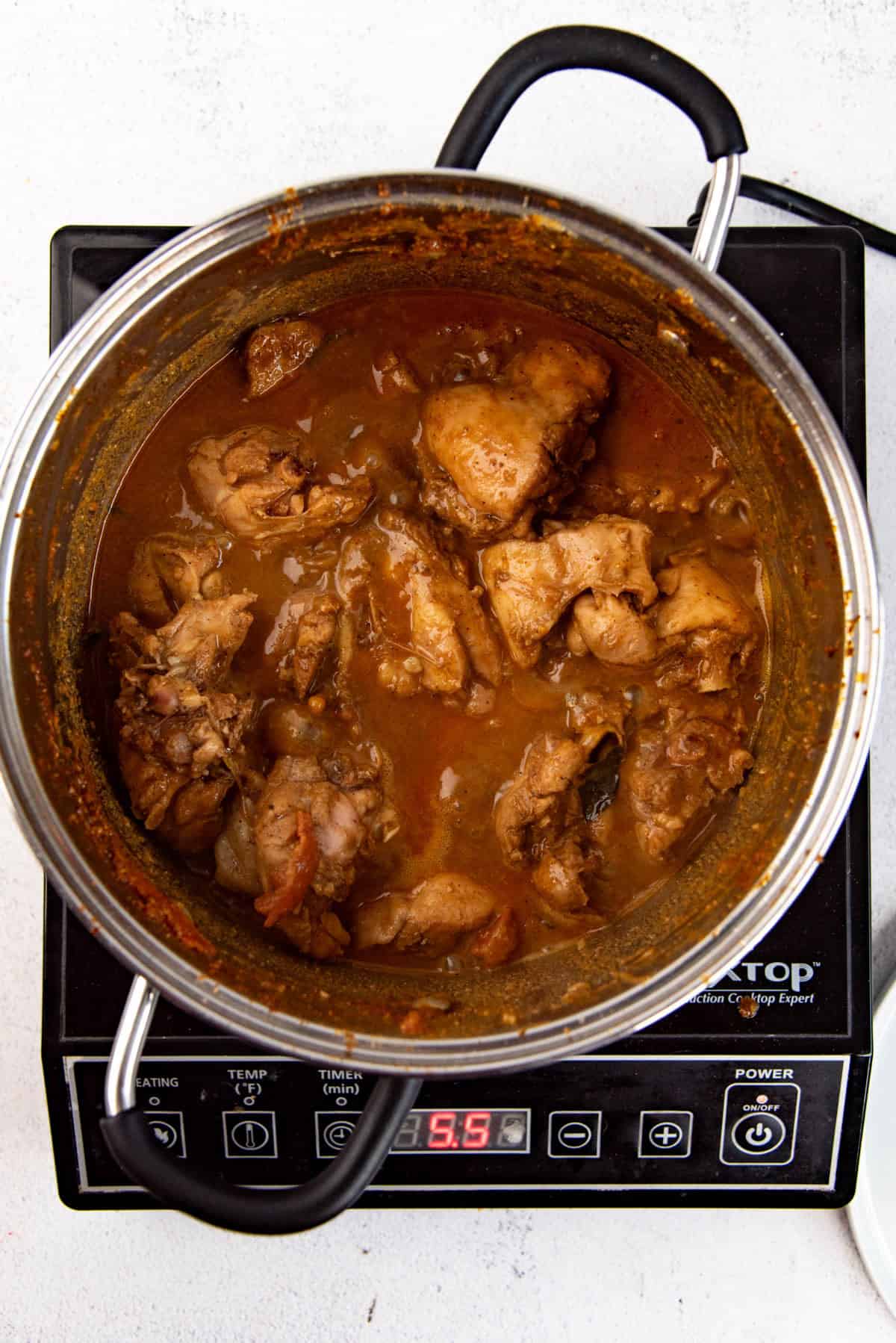 Authentic chicken curry after cooking, still on stove.
