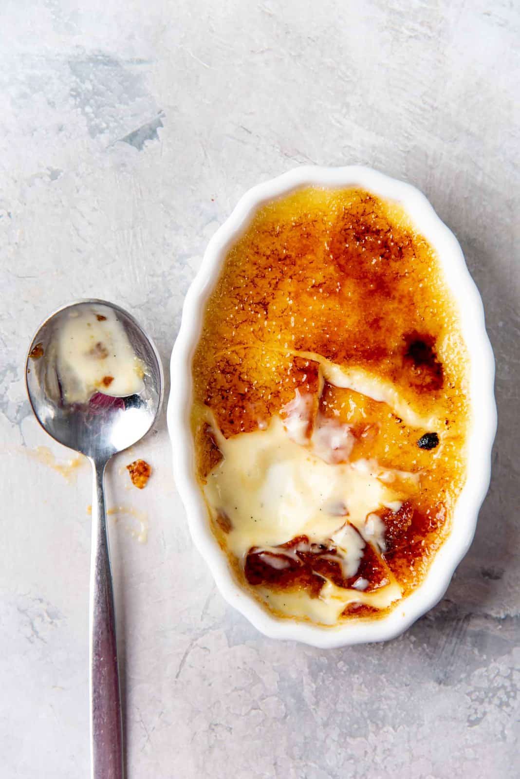 Half eated creme brulee showing the creamy custard underneath