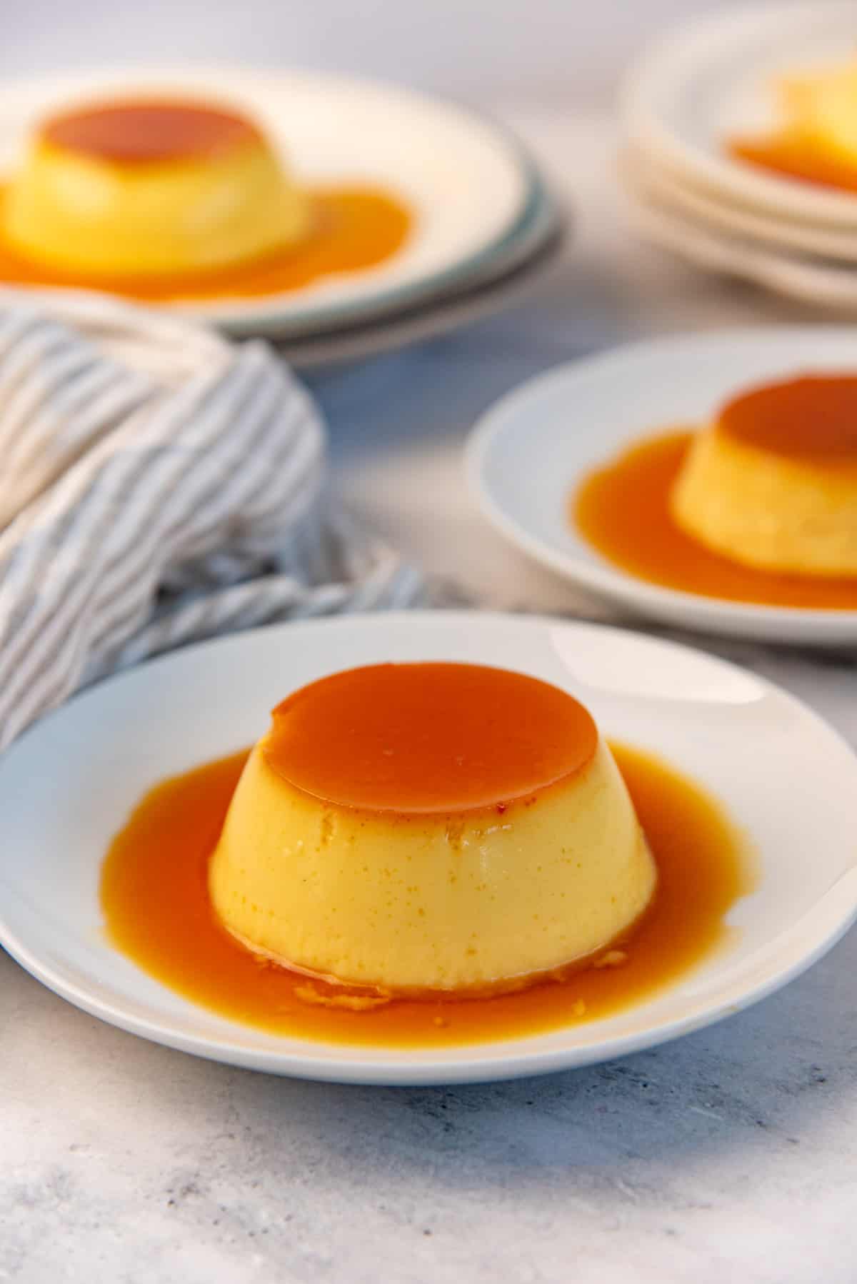 A close up of an unmolded caramel and custard dessert.