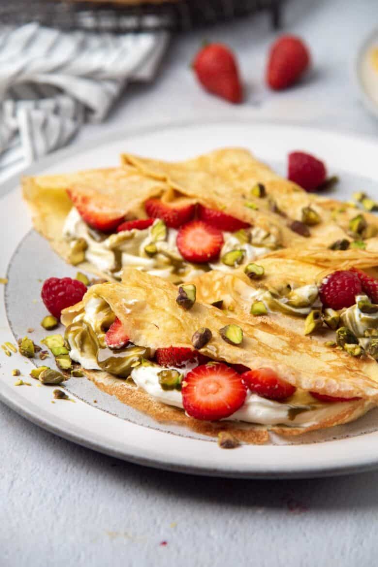 Close up of folded crepes with fillings and toppings