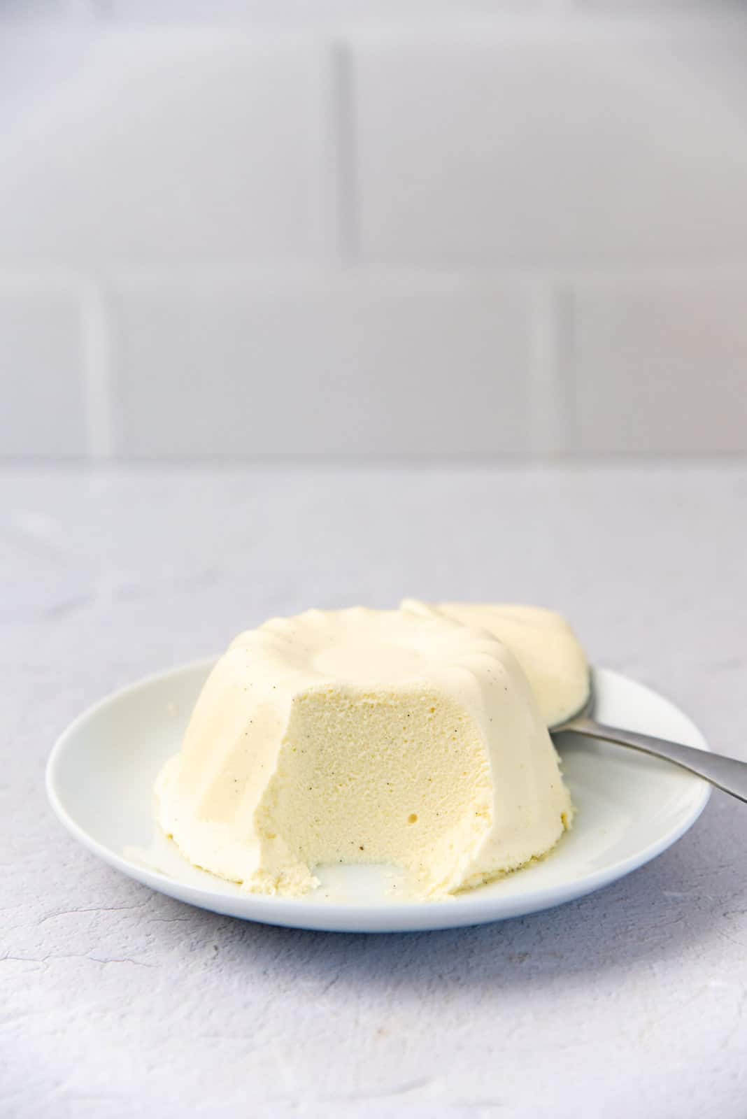Unmolded Bavarian cream served on a white plate.