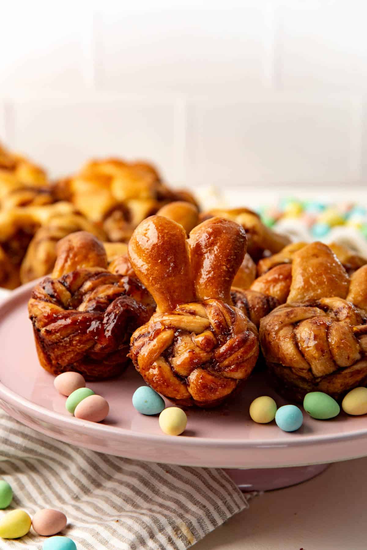 Easter bunny buns on a pink dish with sweet chocolate filling and big floppy ears sticking up to resemble a bunny.