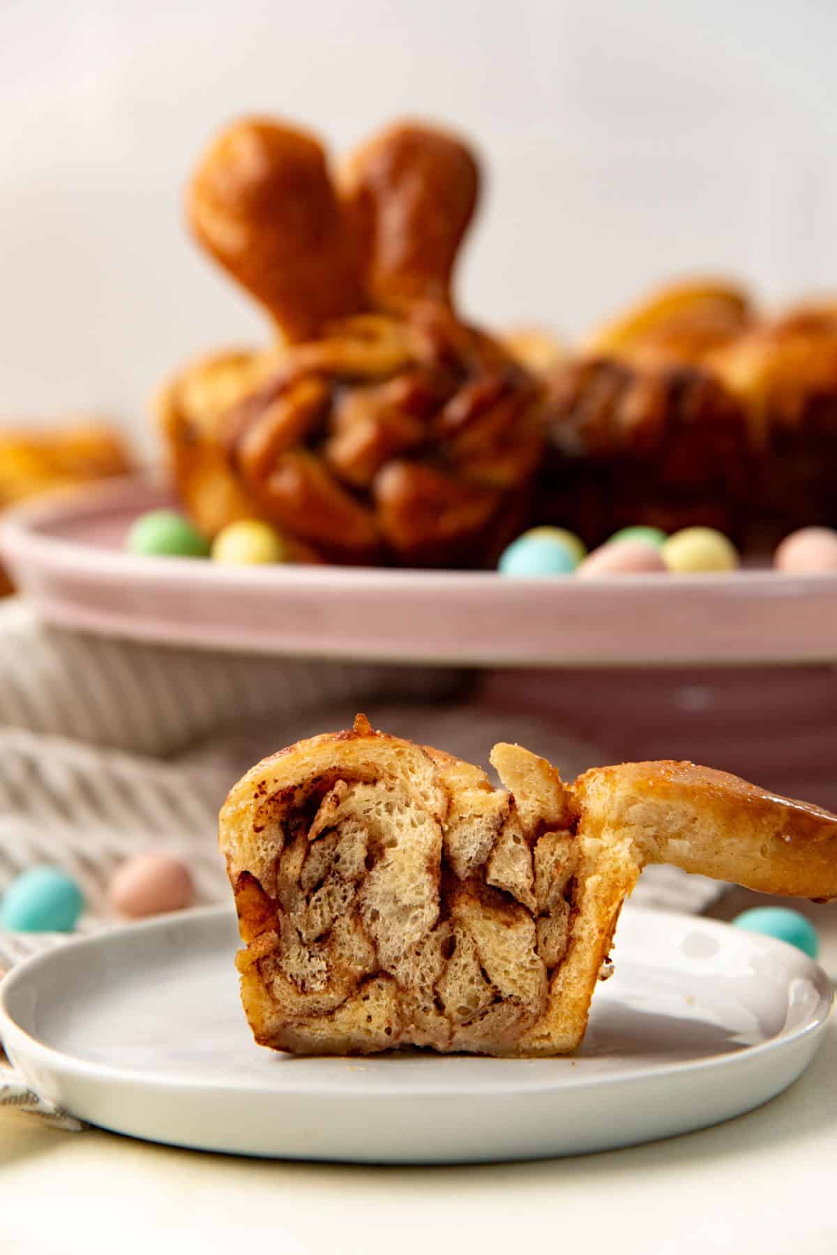 A bunny bun (Easter bun) cut in half to show the cross section of the soft and fluffy bread roll.