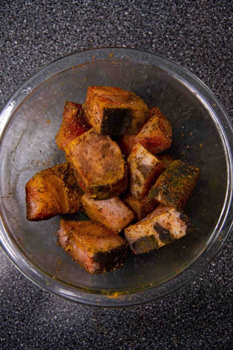 Fish coated in spices in a bowl