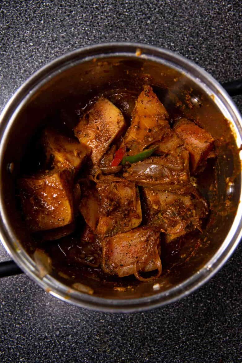 Adding the marinated fish into the pot, and mixed through to coat