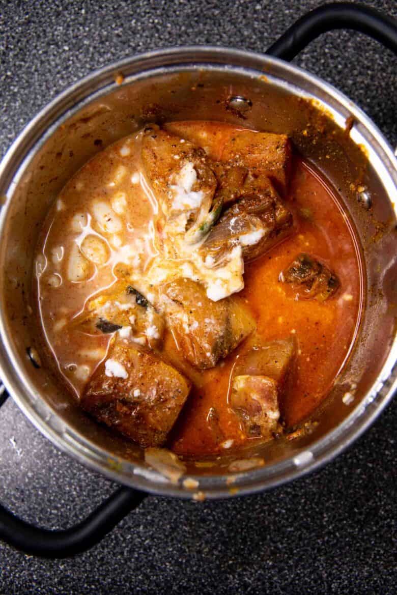 Coconut milk added to the fish curry