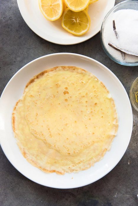 Step one for making lemon and sugar crepes. Lay out the crepe on a plate or flat surface.