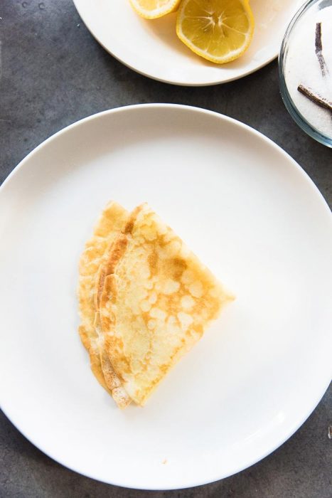 Step 4 to make lemon and sugar vanilla crepes - Fold the crepe in half again. Serve with freshly squeezed lemon juice.
